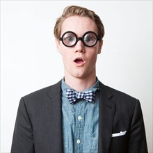 Studio shot of young man wearing funny glasses. Photo : Jessica Peterson