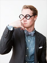 Studio shot of young man wearing funny glasses. Photo : Jessica Peterson