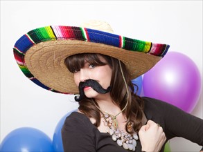Studio Shot of young woman dressed up as Mexican. Photo : Jessica Peterson