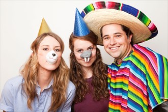 Studio Shot of three people dressed up in animal noses and sombrero. Photo : Jessica Peterson