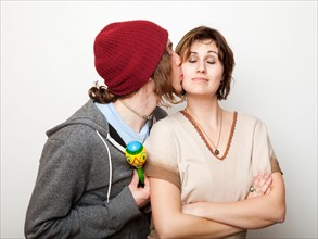 Studio Shot of young man kissing young woman. Photo : Jessica Peterson