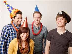 Studio Shot of young people dressed up in party hat. Photo : Jessica Peterson