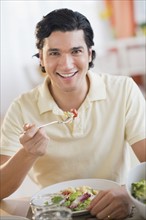 Portrait of man eating dinner.