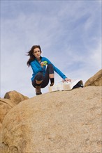 USA, California, Joshua Tree National Park, Female hiker on rocks.
