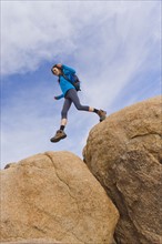 USA, California, Joshua Tree National Park, Female hiker on rocks.