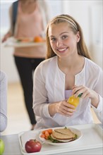 Female student (16-17) having lunch.