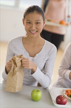 Female student (14-15) having lunch.