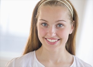 Portrait of girl (16-17) smiling.