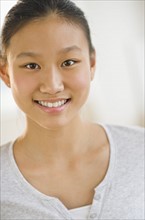 Portrait of girl (14-15) smiling.