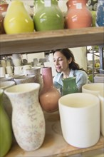 Female artist in pottery in studio.
