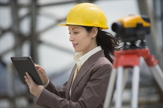 Architect using digital tablet in construction site.