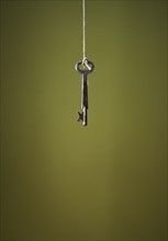 Key hanging on string.