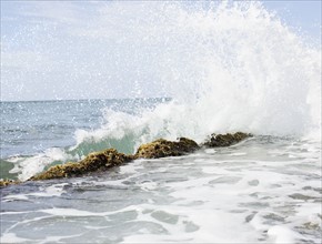 USA, Puerto Rico, Ricon, Surf splashing on rocks. 
Photo: Jamie Grill