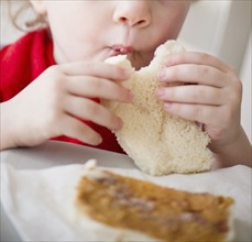 Girl (2-3) eating sandwich. 
Photo: Jamie Grill