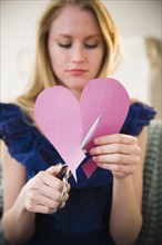 Woman cutting paper heart. 
Photo: Jamie Grill