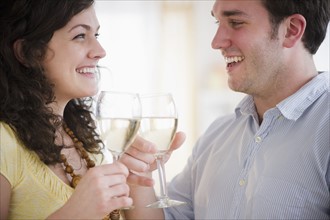 Couple toasting with wine. 
Photo : Jamie Grill