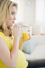 Pregnant woman drinking juice. 
Photo : Jamie Grill