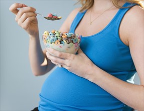 Pregnant woman eating cereal. 
Photo : Jamie Grill