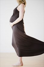 Pregnant woman touching belly. 
Photo : Jamie Grill