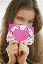 Woman holding valentine card. 
Photo: Jamie Grill
