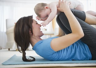 Mother with baby daughter (6-11 months) practicing yoga. 
Photo: Jamie Grill