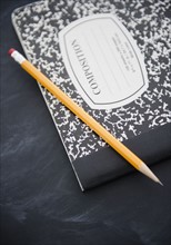 Close up of composition book and pencil. 
Photo : Jamie Grill