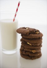 Close up of glass of milk and chocolate cookies. 
Photo : Jamie Grill
