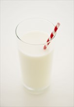 Close up of glass of milk with straw. 
Photo : Jamie Grill