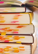 Close up adhesive notes in books, studio shot. 
Photo: Daniel Grill