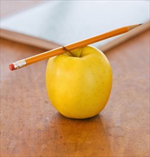 Close up of pencil on apple, studio shot. 
Photo: Daniel Grill
