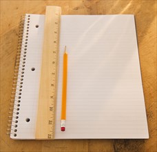 Close up of notebook, ruler and pencil, studio shot. 
Photo : Daniel Grill
