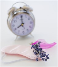 Close up of lavender, alarm clock and sleep masks, studio shot. 
Photo: Daniel Grill
