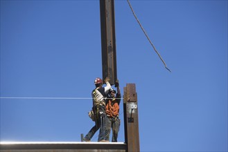 Construction workers on construction frame. 
Photo: fotog