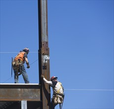 Construction workers on construction frame. 
Photo: fotog