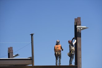 Construction workers on construction frame. 
Photo : fotog