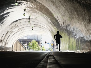 USA, California, Los Angeles, Man running in tunnel. 
Photo: Erik Isakson