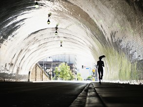 USA, California, Los Angeles, Woman running in tunnel. 
Photo: Erik Isakson