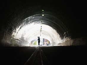 USA, California, Los Angeles, Woman running in tunnel. 
Photo: Erik Isakson