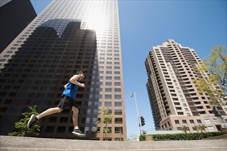 USA, California, Los Angeles, Young man running in city.