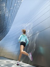 USA, California, Los Angeles, Young woman jogging in city.