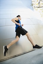 USA, California, Los Angeles, Young man jogging in city.