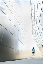 USA, California, Los Angeles, Young woman jogging in city.