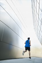 USA, California, Los Angeles, Young man jogging in city.