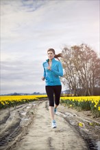 USA, Washington, Skagit Valley, Woman running in rural area. 
Photo : Take A Pix Media