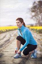 USA, Washington, Skagit Valley, Woman exercising in rural area. 
Photo : Take A Pix Media