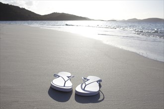 United States Virgin Islands, St. John, Pair of flip flops left on empty beach. 
Photo: Winslow