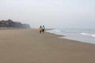 France, Pas-de-Calais, Escalles, Two women strolling on empty beach. 
Photo: Jan Scherders