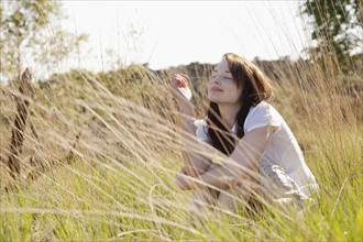 Young woman relaxing on meadow. 
Photo : Jan Scherders