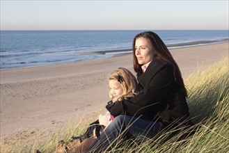 Netherlands, Zeeland, Haamstede, Mother with daughter on beach. 
Photo: Jan Scherders