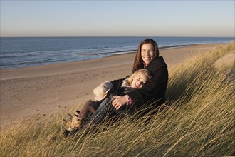 Netherlands, Zeeland, Haamstede, Mother with daughter on beach. 
Photo: Jan Scherders